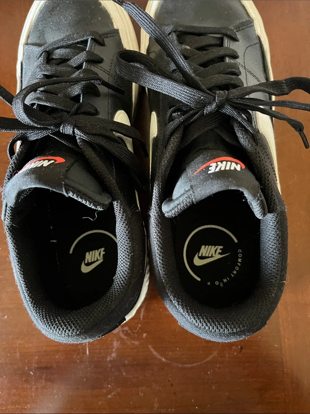 Nike Women’s Black Sneakers with White Swoosh and Red Tongue Logo